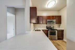 White Quartz Counter With Custom Cabinetry In Kitchen at Pavona Apartments, 95112, CA