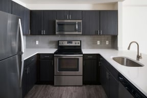Espresso Cabinetry and White Countertops at The Manhattan Tower and Lofts, 1801 Bassett Street, Denver