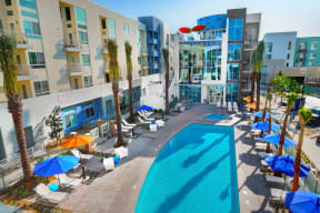 Sundeck with Lounge Chairs and Shade Umbrellas at Boardwalk by Windsor, 92647, CA