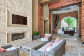 Outdoor Lounge With Fireplace And Television at Windsor at Cambridge Park, 02140, MA