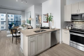 Stunning kitchens feature quartz countertops and tiled backsplash at Windsor Mystic River, Massachusetts, 02155