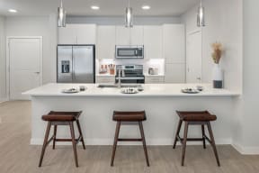 Stunning kitchens feature quartz countertops and subway tile backsplash at Windsor South Congress, Austin, 78745