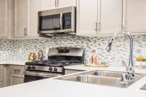 sleek stainless appliance package at Valentia by Windsor, La Habra, CA, 90631