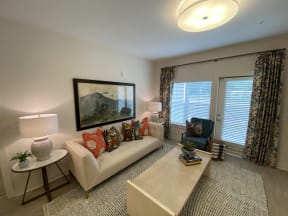 Two-Bedroom Summerville Apartments for Rent - Duke of Charleston - Spacious Living Room with White Walls, Wood-Style Flooring, and Private Patio Access
