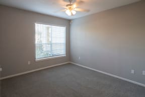 Bedroom with large window located at The Moorings Apartments, League City TX 77573
