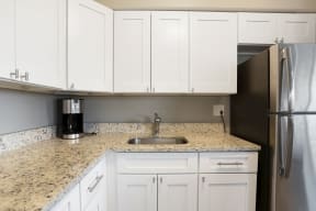 Kitchen with sink, coffee maker and cabinets