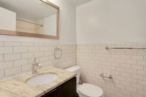 Bathroom with vanity, mirror, toilet