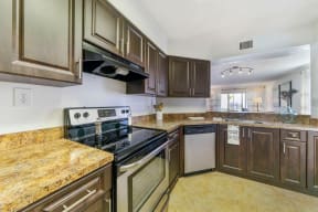 Kitchen with cabinets, sink, stainless steel oven and dishwasher