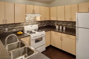 803 Corday at Naperville - Fully-Equipped Kitchen with Plenty of Cabinet Space, Stainless Steel Sink, and Tile Backsplash