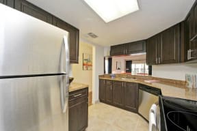 Kitchen with cabinets, stainless steel refrigerator, dishwasher, and oven