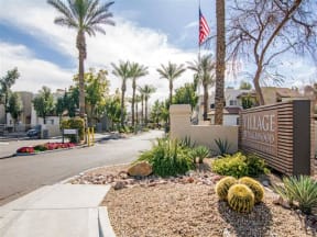 Apartments for Rent in Phoenix, AZ - Village at Lakewood Front Sign with Greenery and Gated-Access