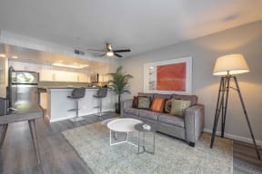Apartments for Rent in San Clemente CA - Rancho Del Mar - Living Room with Wood-Style Flooring, Grey Walls, and Ceiling Fan