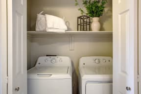Full-size side by side washer and dryer located in hallway