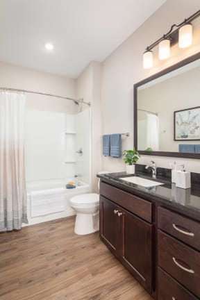 View of spacious, modern bathroom at The Whitley apartments.