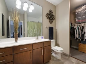 Be @ Axon Green  Apartment Bathroom with Sink, Toilet, White Counters, and partial Walk-In Closet