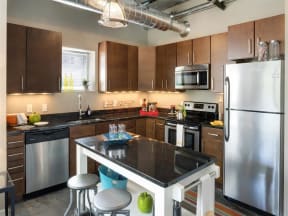 Be @ Axon Green Apartment Kitchen with Kitchen Island, Refrigerator, Oven, Dishwasher, Microwave and Sink