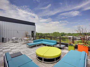 Be @ Axon Green Rooftop Patio and Sitting Area with couches, chairs, and tables