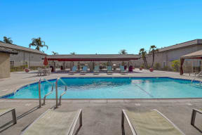Pool side view at El Dorado Apartments with Poolside chairs