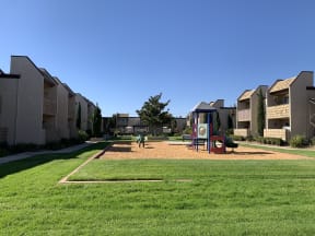 Center grass area with playground and pool in the back
