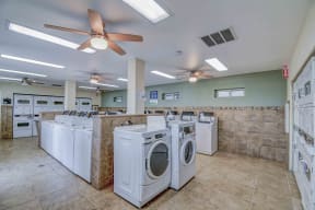 Laundry Room with dryers on both sides and washers in the center of the room