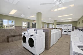 Laundry Facility with washers and dryers and ceiling fans
