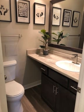 Full Bathroom With Oversized Countertops & Framed Mirror