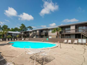 Pool at Atwood Oaks with an expansive sundeck and pool furniture.