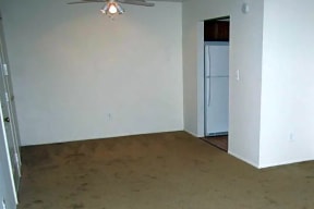 Living and dining area with beige carpet and ceiling fan