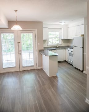 Renovated kitchen with plank flooring and granite countertops