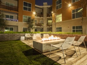 Apartments in San Mateo for Rent - Mode Apartments - Fire Pit and Seating Surrounded by Mode Building
