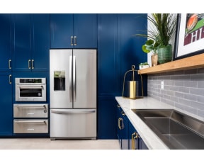 community kitchen with stainless steel fridge and kitchen