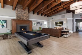 Clubroom with billiards table and fireplace