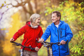 Man and Woman Smiling Riding Bikes