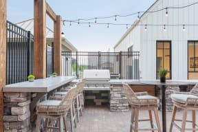 Outdoor bar tops with grilling stations and outdoor string lights | www.lemmondfarm.com
