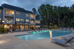 exterior dusk image of pool deck and clubhouse