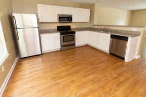Dana Downs Spacious Kitchen Featuring Convenient Amenities Such as a Stainless Steel Fridge, Stove, Microwave, and Dishwasher