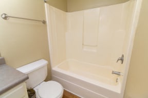 Dana Downs Bathroom with Hardwood Floors Featuring Tub and Toilet