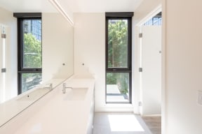 Master Bathroom with Long Window, Counter Space, Sink, All White Walls at 10 Clay Apartments in Seattle, Washington,98121
