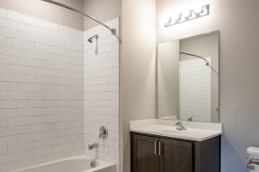 Bathroom with curved shower rod and high-end shower tiling