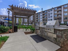 Outdoor Grilling Area with Fire Pit  at Berewick Pointe Apartments in North Carolina