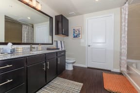 Agora Stone Oak Bathroom with Wood-Style Flooring and Framed Mirror