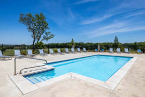 Apartments for Rent in Lawrence - Fairway Flats - Pool Area with Lounge Chairs and Views of Lush Greenery