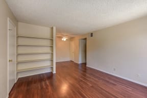 Empty Living Room with Hardwood Inspired Floors, Ceiling Fan/Light and White Door