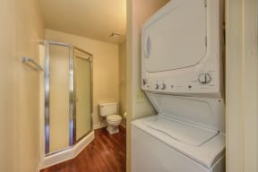 Bathroom with Washer/Dryer, Wood Inspired Floors, Toilet and Shower