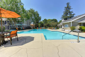 Pool Entrance with  Lounge Chairs, Trees and Apartment Exteriors at Pinecrest Apartments, Davis, California