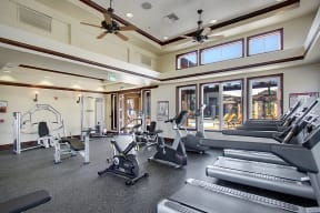 Apartments in Rancho Cucamonga CA - Expansive Fitness Center Featuring Various Cardio Equipment