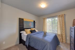 Spare Bedroom with Blue Comforter on Mattress, Open Window, Yellow Blinds, Carpet, Woven Dog,