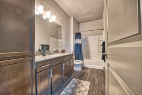 apartments baths feature granite tops and wood style flooring