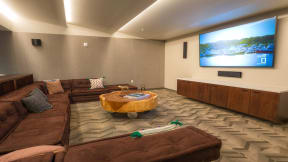 Virtual reality room with large TV and ample couch seating