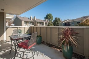 Patio with table and chair Apartments in Pittsburg, CA l Kirker Creek Apartments